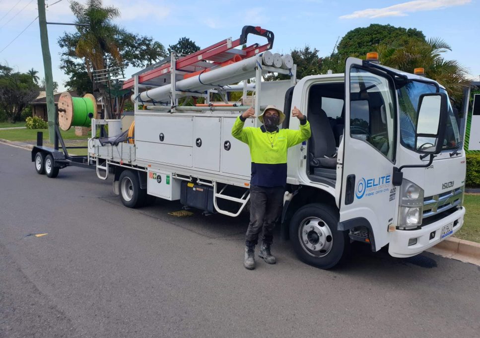 Man Happy Beside The White Truck — Fibre Optic Installation in Logan, QLD